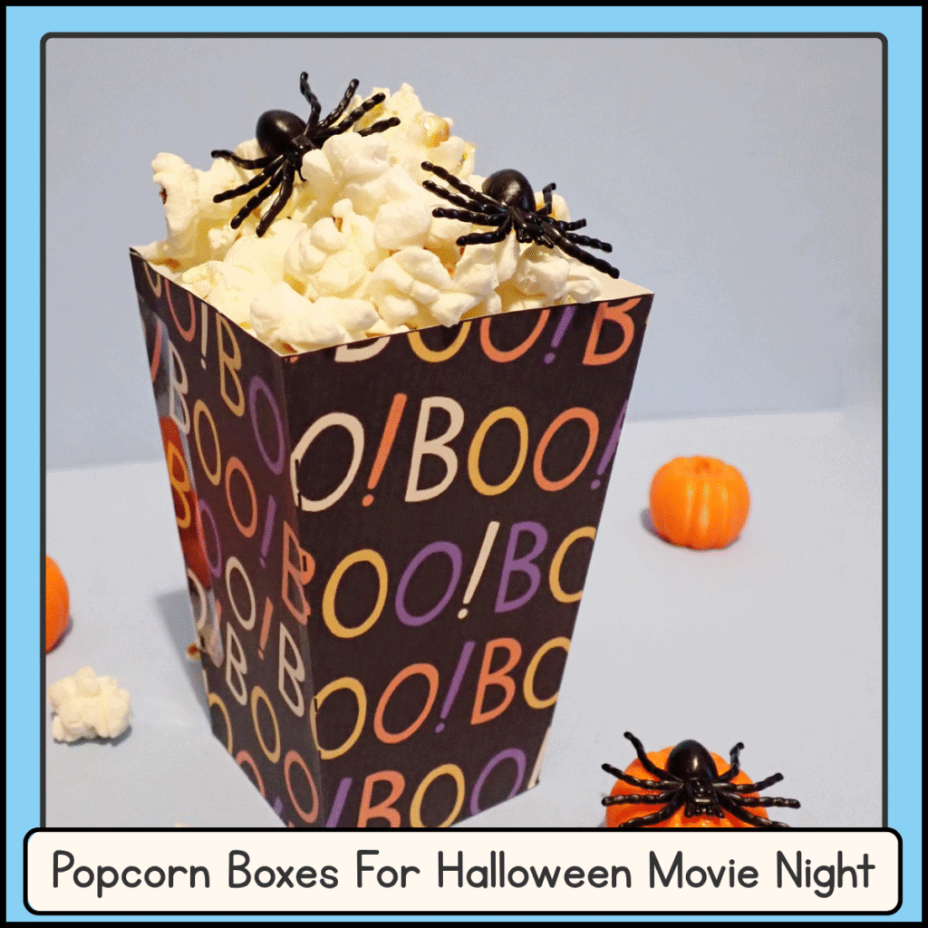 printable Halloween popcorn box with the words BOO! written on it and toy spiders sitting on top of the popcorn